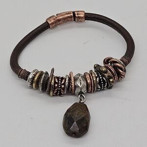 brown cord bracelet with multimetal beads and faux stone charm